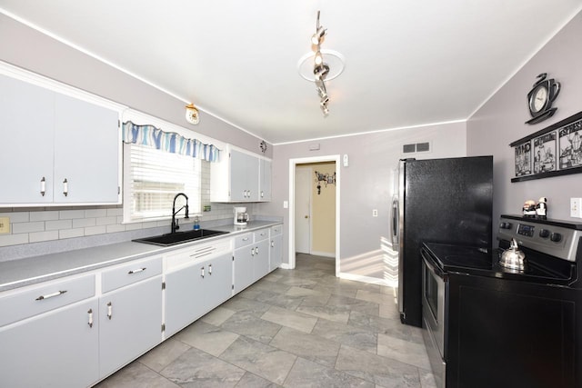 kitchen with stainless steel appliances, white cabinetry, sink, and decorative backsplash