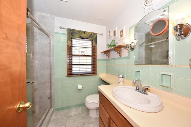 bathroom featuring tile walls, tile patterned flooring, vanity, walk in shower, and toilet