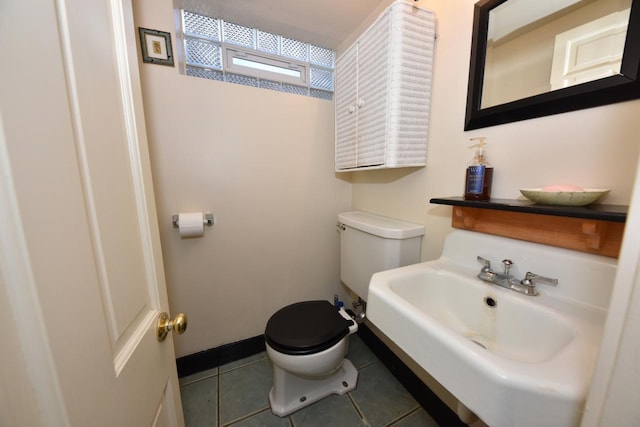 bathroom with sink, tile patterned floors, and toilet