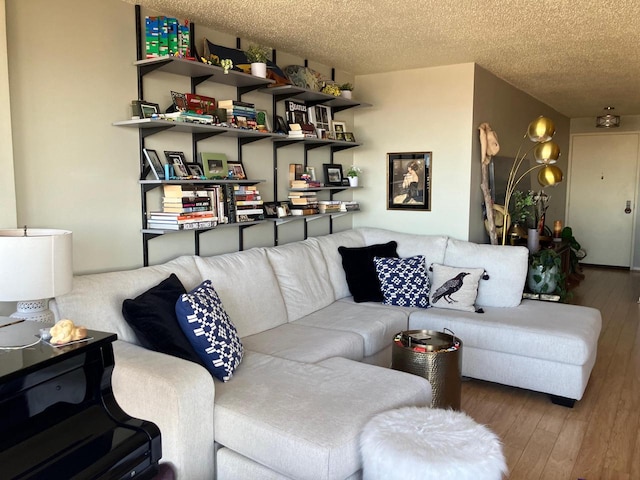 living room featuring hardwood / wood-style flooring and a textured ceiling