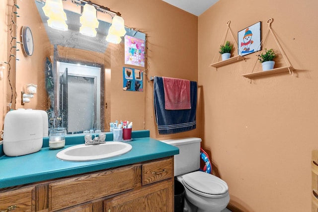 bathroom featuring vanity and toilet