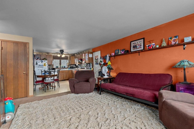 living room with light colored carpet and ceiling fan