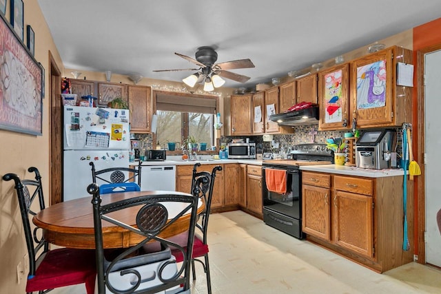 kitchen with refrigerator, tasteful backsplash, dishwasher, ceiling fan, and black / electric stove