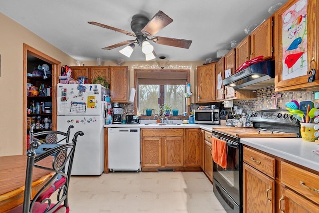 kitchen with sink, white appliances, ceiling fan, backsplash, and extractor fan