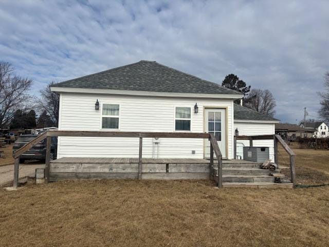 rear view of house with a yard