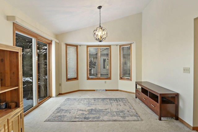 interior space with lofted ceiling and a notable chandelier