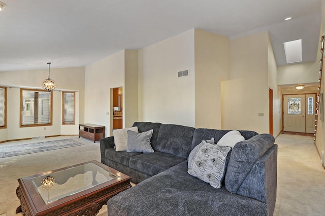 living room featuring light carpet, vaulted ceiling, and an inviting chandelier