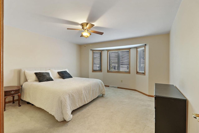 bedroom with light colored carpet and ceiling fan