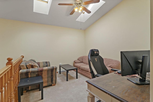 office featuring lofted ceiling with skylight, light carpet, and ceiling fan