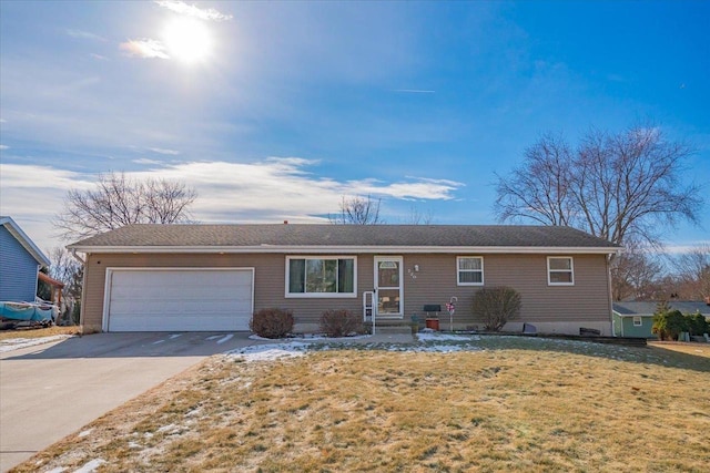 ranch-style house with a garage and a front yard