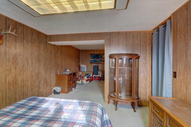 carpeted bedroom featuring wooden walls