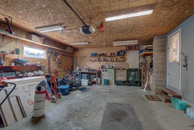 garage featuring a garage door opener and a workshop area