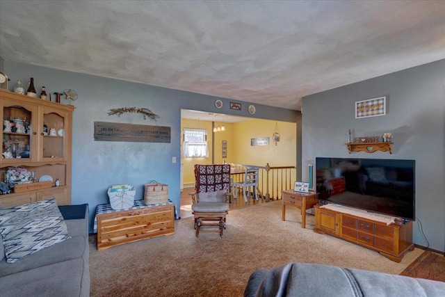 carpeted living room featuring a textured ceiling