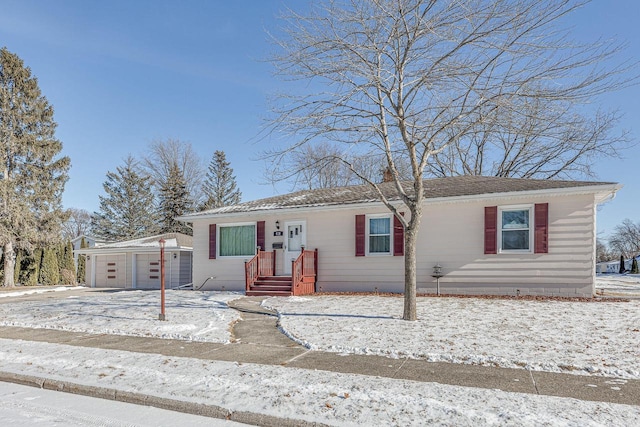 single story home featuring an outbuilding and a garage