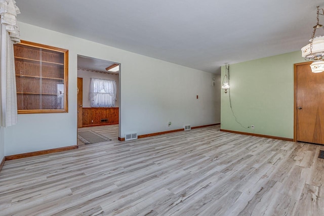 spare room featuring light hardwood / wood-style flooring