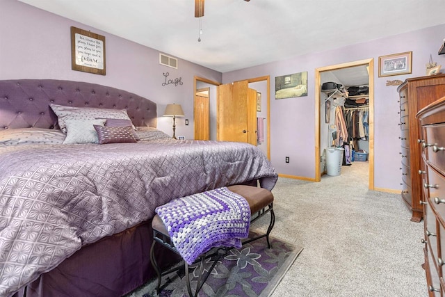 bedroom featuring ceiling fan, a walk in closet, carpet, and a closet