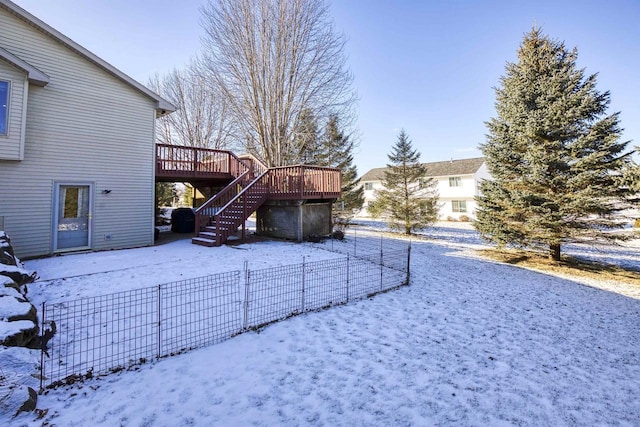 yard covered in snow featuring a wooden deck