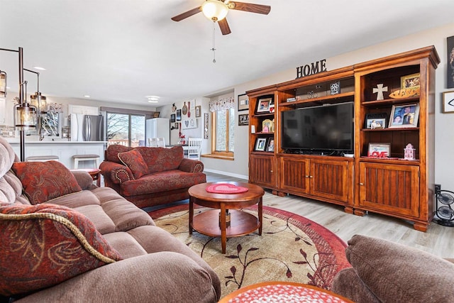 living room featuring ceiling fan and light wood-type flooring