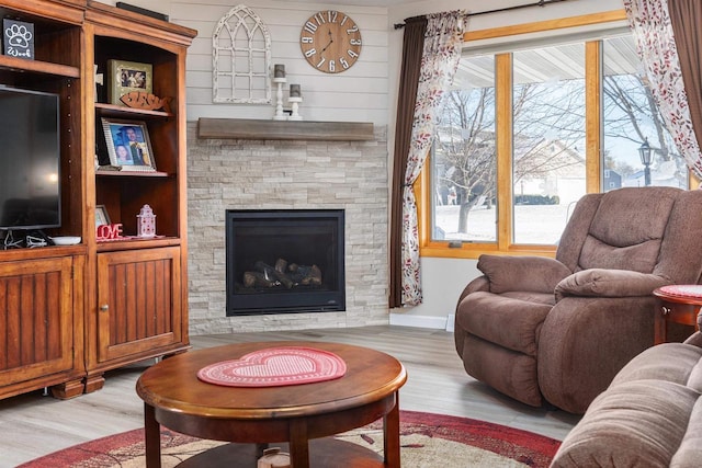 living room with a fireplace and light hardwood / wood-style flooring