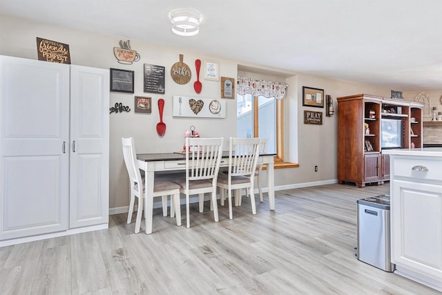 dining area with light hardwood / wood-style floors