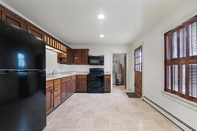 kitchen featuring a baseboard radiator, sink, water heater, and black appliances