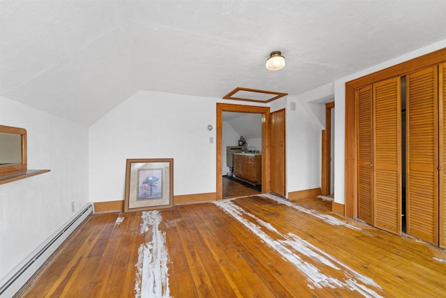 bonus room with lofted ceiling, hardwood / wood-style floors, and baseboard heating