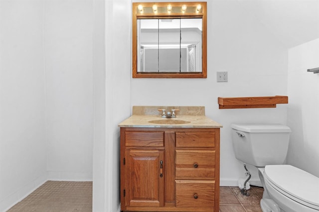 bathroom with vanity, tile patterned floors, and toilet