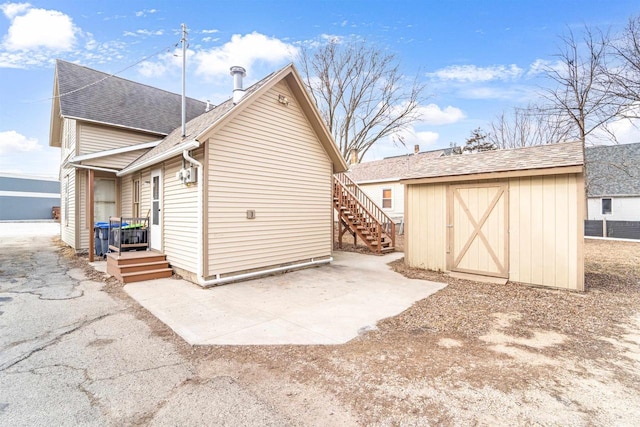 back of property with a storage unit