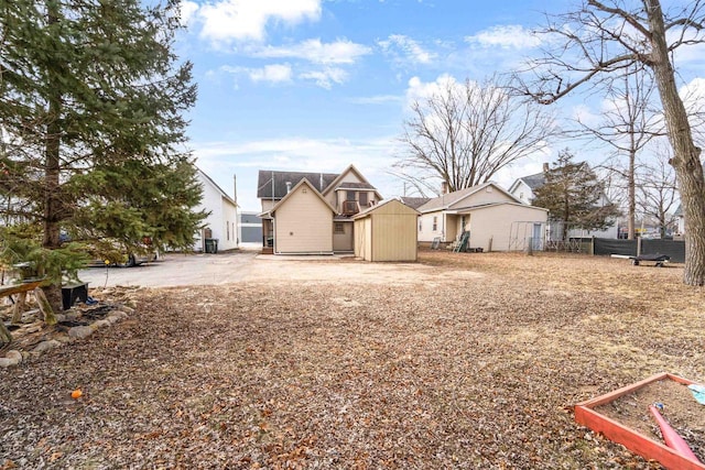 view of front of property with a storage shed