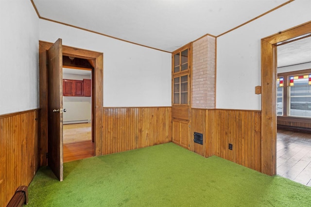 spare room featuring crown molding and a baseboard radiator