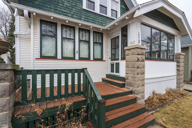 view of exterior entry featuring a wooden deck