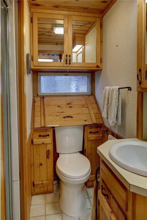 bathroom featuring tile patterned floors, vanity, toilet, and wooden ceiling