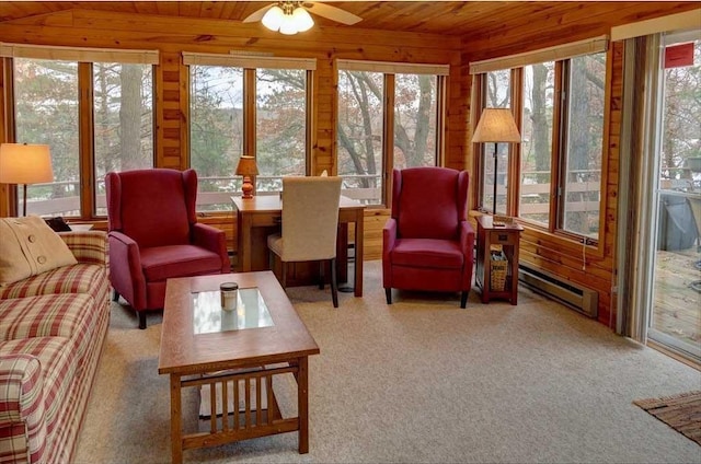 sunroom featuring a baseboard radiator, wooden ceiling, and vaulted ceiling