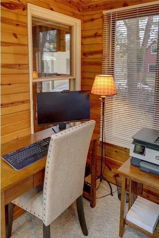 office space featuring carpet and wooden walls