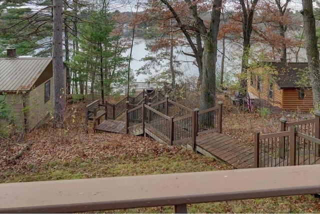 view of yard featuring a deck with water view