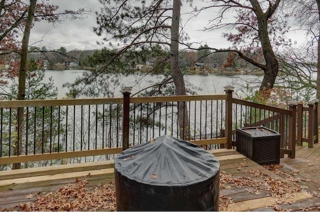 deck featuring a grill and a water view