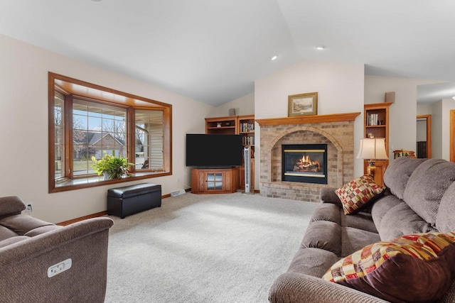 carpeted living room featuring a brick fireplace and vaulted ceiling