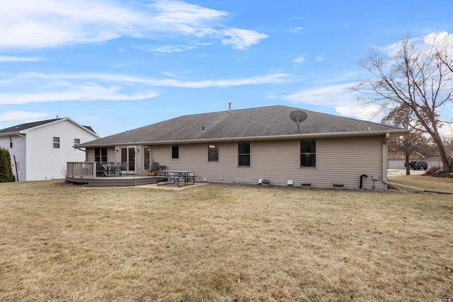 rear view of house with a yard and a deck