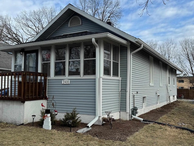 view of side of home with a sunroom