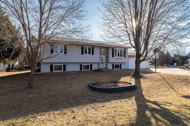 raised ranch with a garage and a front yard