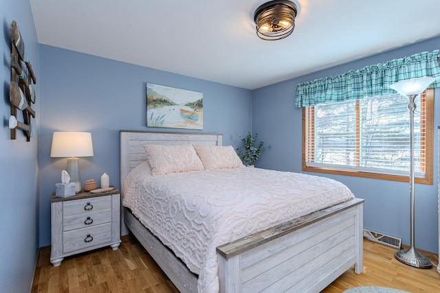 bedroom with hardwood / wood-style floors