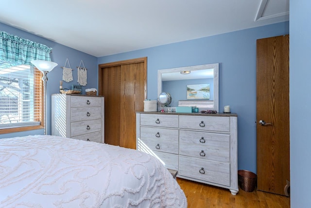 bedroom featuring light hardwood / wood-style floors and a closet