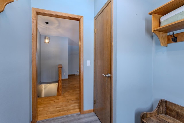 corridor with light hardwood / wood-style floors