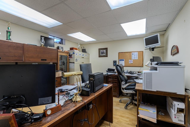 office area featuring a drop ceiling and light hardwood / wood-style flooring