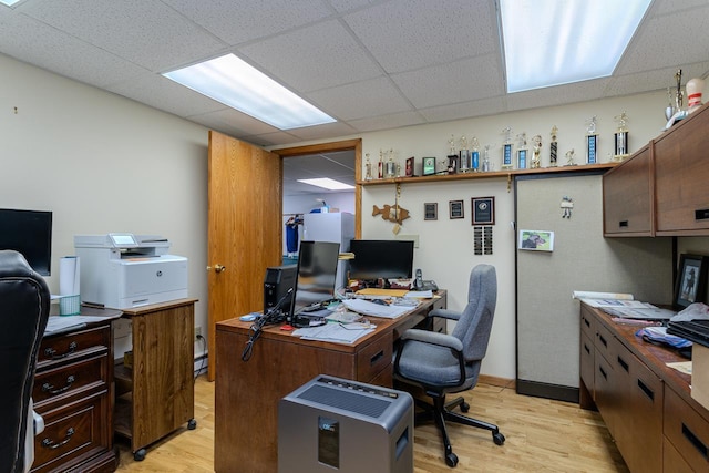 office with a paneled ceiling and light hardwood / wood-style floors