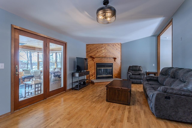 living room with a large fireplace and light hardwood / wood-style floors