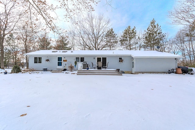 view of snow covered back of property