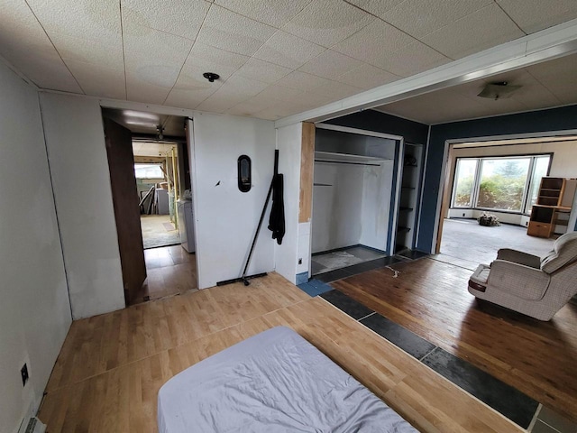 bedroom with hardwood / wood-style floors and a closet