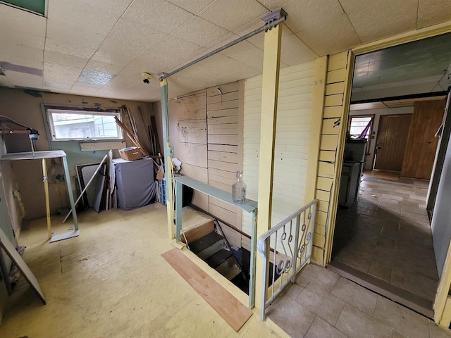 miscellaneous room featuring wood walls