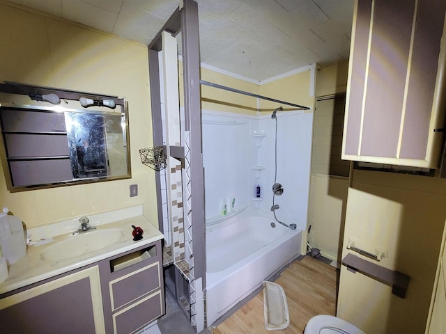 bathroom with bathing tub / shower combination, wood-type flooring, vanity, and crown molding